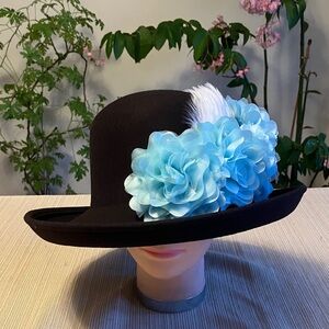 Elegant Black Wool Hat with Blue Floral Accents and White Feather Accents